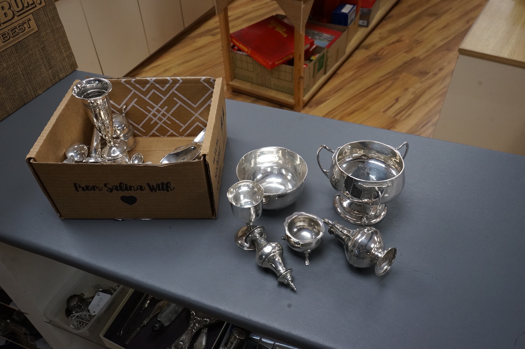 A collection of small silver including an Edwardian Art Nouveau tri-handled pedestal bowl, Birmingham, 1909, height 90mm, a sugar bowl, three cigarette cases, goblet, communion jug, five condiments, three napkin rings, e